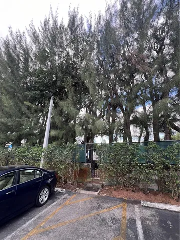 a backyard of a house with barbeque oven table and chairs