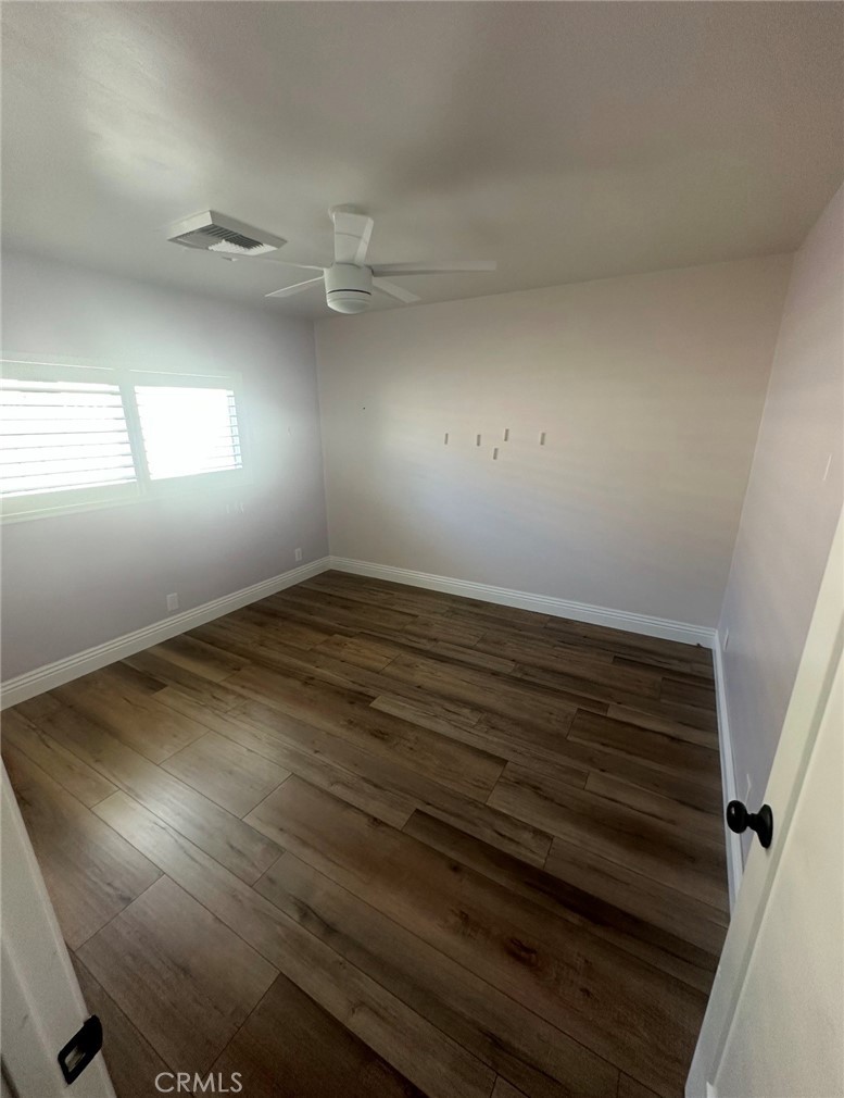 1113 Riedel Avenue Fullerton, CA 92831 - Photo 3 of 8 an empty room with wooden floor and windows