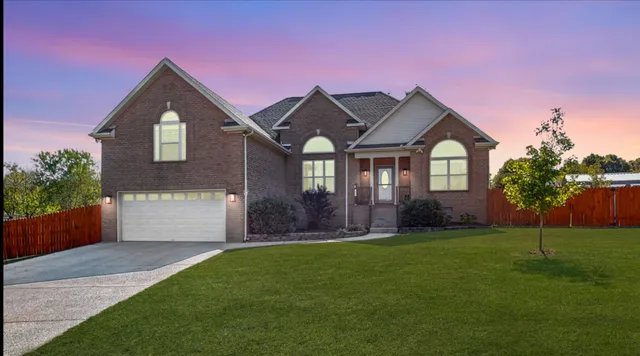 a front view of a house with a yard and garage