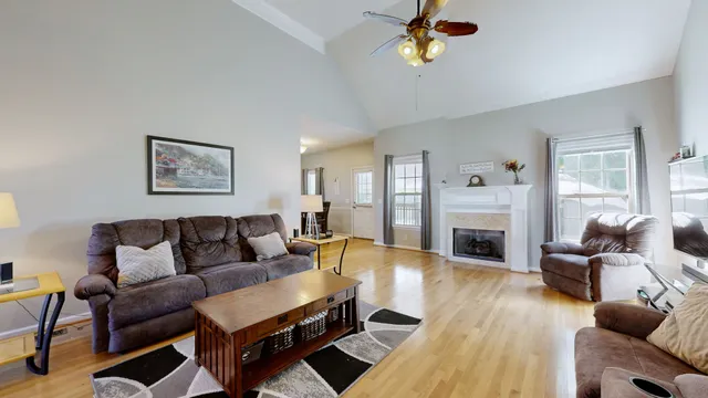 a living room with fireplace furniture and a wooden floor