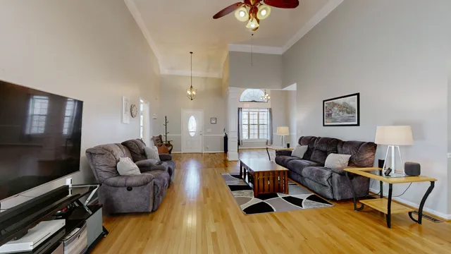 a living room with furniture and a flat screen tv