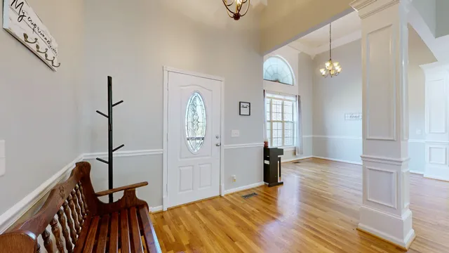 a view of a room with furniture and wooden floor