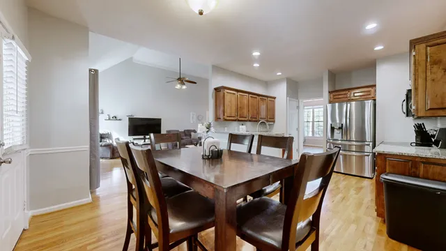 a dining room with furniture and a kitchen view