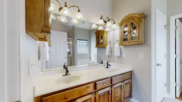 a bathroom with double vanity sink and a mirror