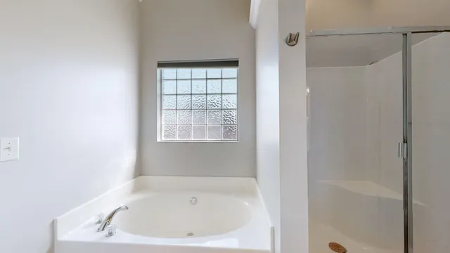 a white bath tub sitting next to a window