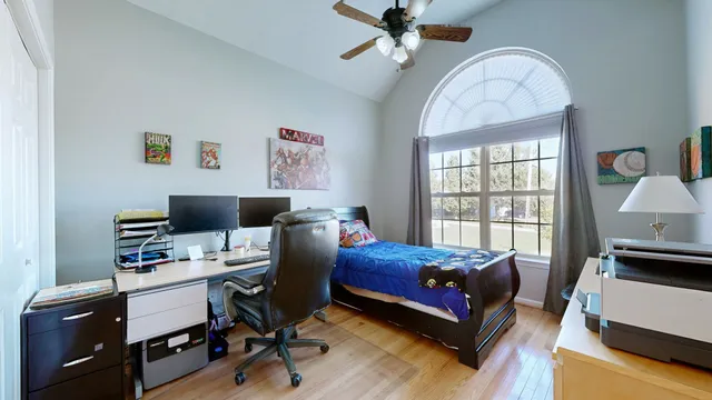 a bedroom with a bed and a chandelier