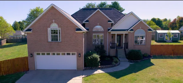 a view of a house with a yard potted plants