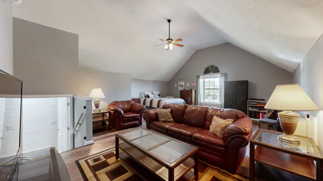 a living room with furniture a lamp and a window