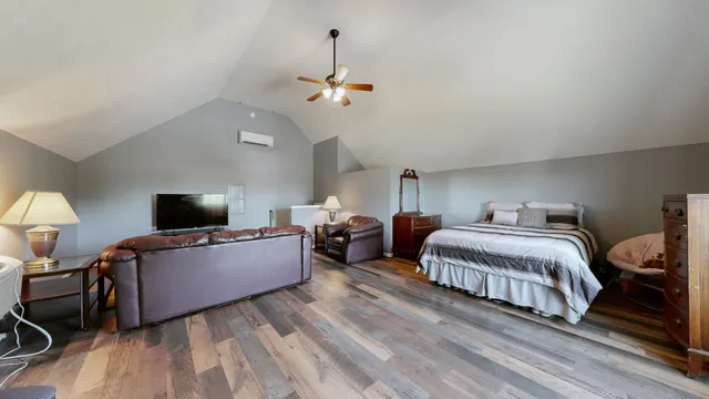 a bedroom with bed and a chandelier