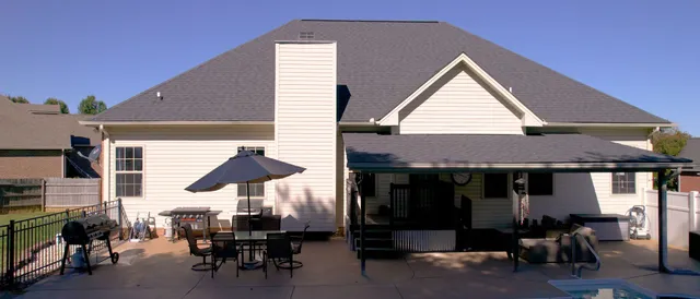 a view of a cafe with table and chairs under an umbrella