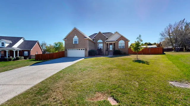 a front view of a house with a yard