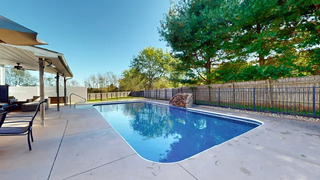 a view of swimming pool with chairs