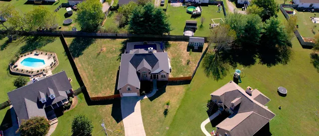 an aerial view of a house with a swimming pool