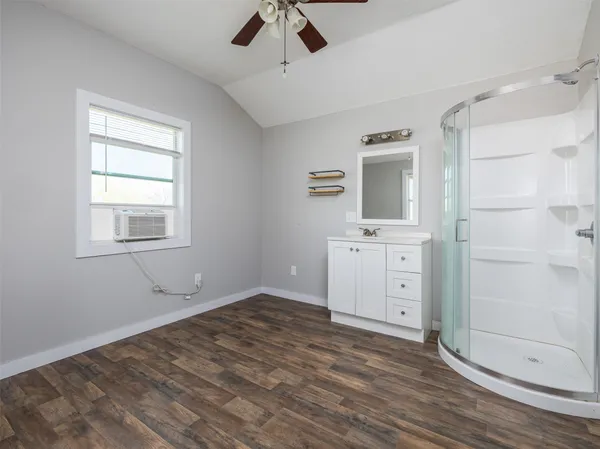 an empty room with a bathroom and sink