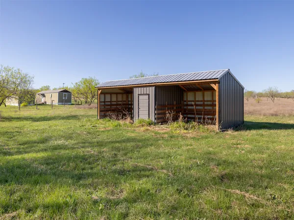 a backyard of a house with yard and outdoor seating