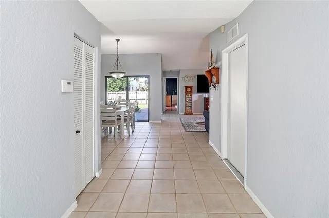 a large kitchen with granite countertop a sink and a refrigerator