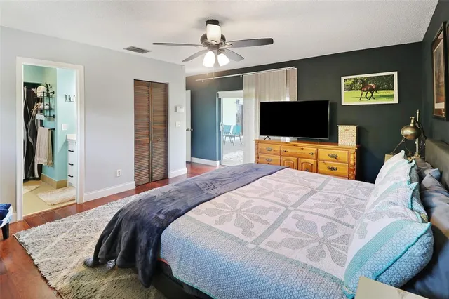 a bedroom with a bed and a flat screen tv