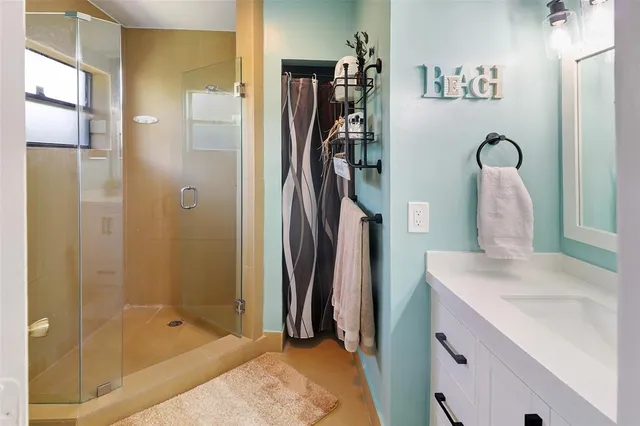 a bathroom with a sink tub and a shower