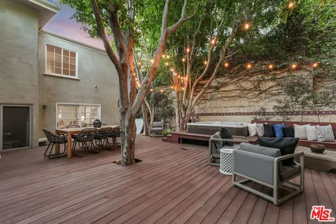 a view of a table and chairs in patio of the house