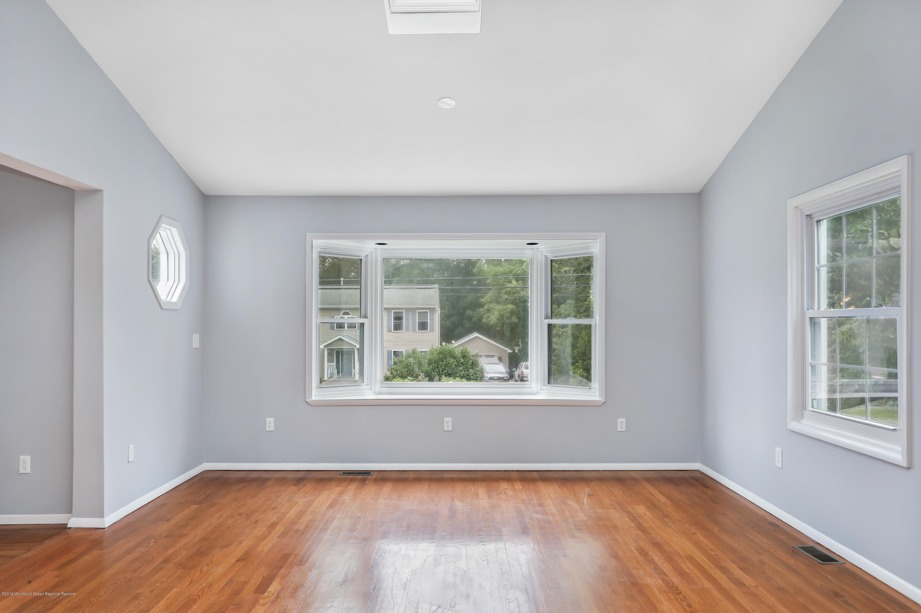 1822 Carmerville Road Wall, NJ 07719 - Photo 12 of 25 a view of an empty room with wooden floor and a window
