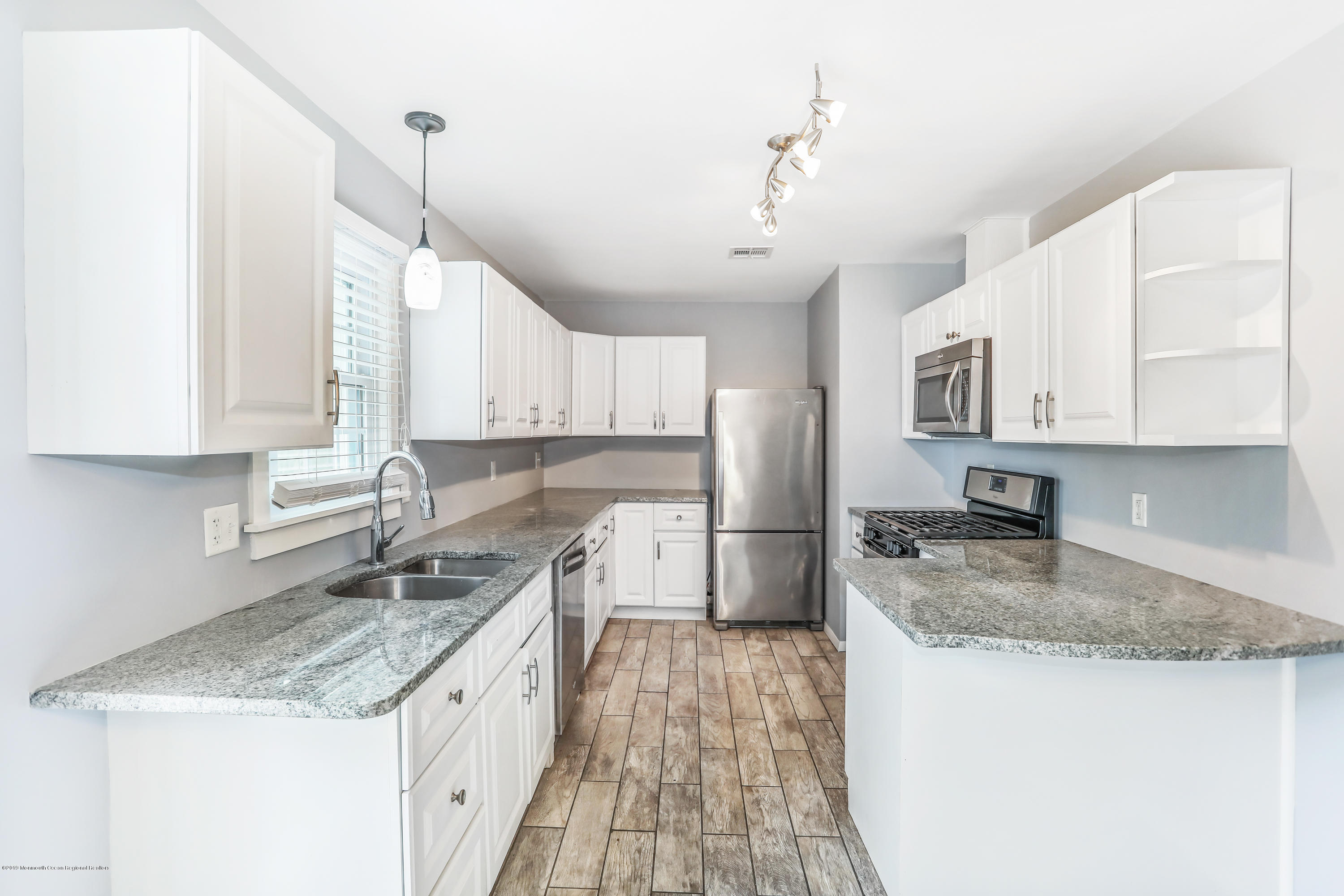 1822 Carmerville Road Wall, NJ 07719 - Photo 13 of 25 a kitchen with stainless steel appliances granite countertop a sink stove and refrigerator
