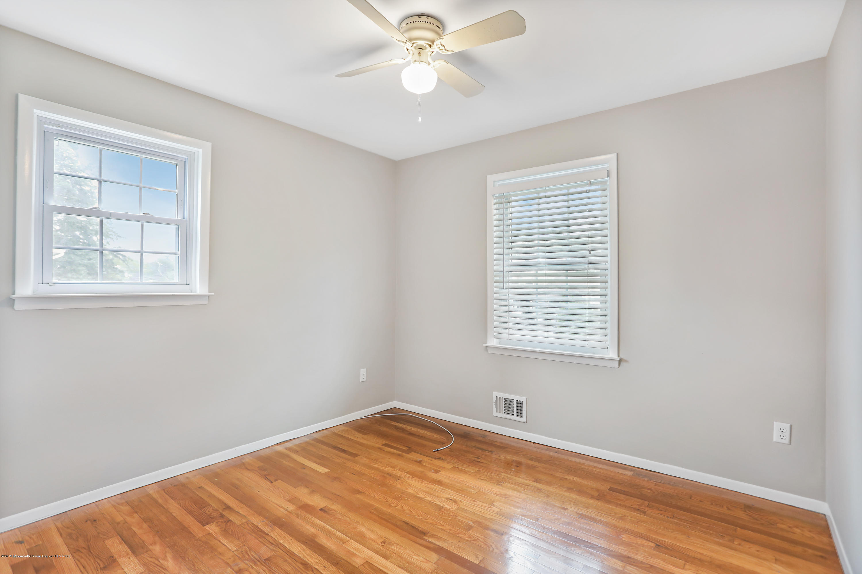 1822 Carmerville Road Wall, NJ 07719 - Photo 20 of 25 a view of an empty room with window and wooden floor