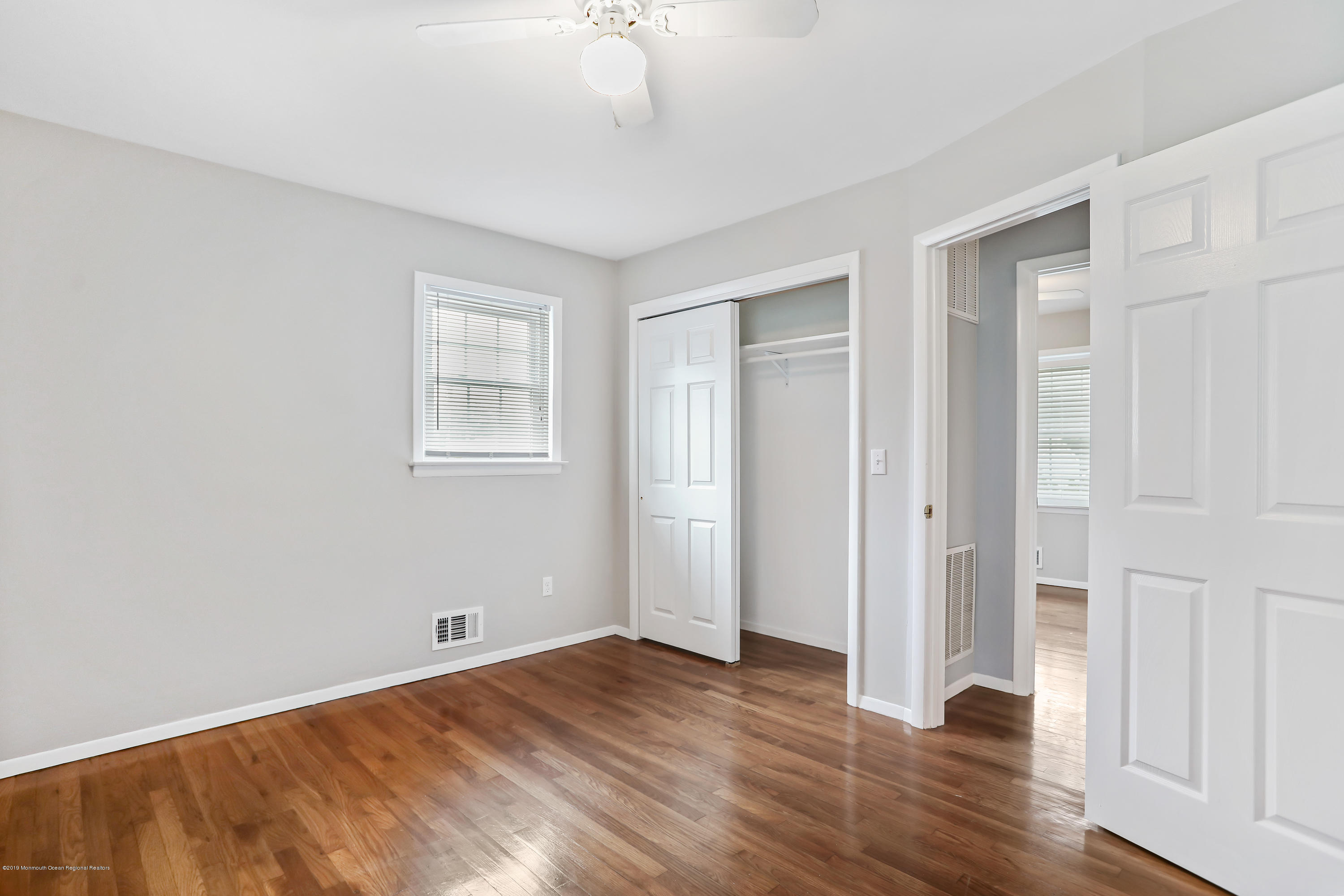 1822 Carmerville Road Wall, NJ 07719 - Photo 21 of 25 an empty room with wooden floor and windows