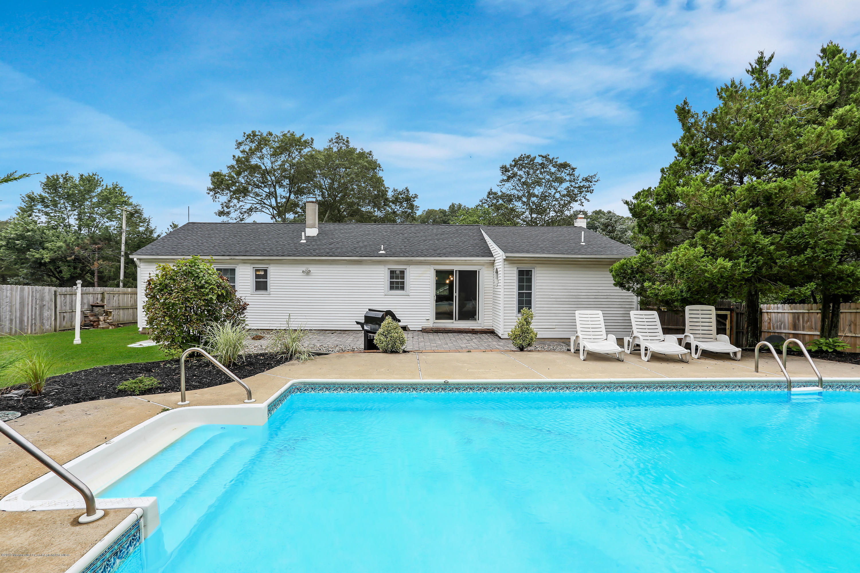 1822 Carmerville Road Wall, NJ 07719 - Photo 5 of 25 a front view of house with yard and outdoor seating
