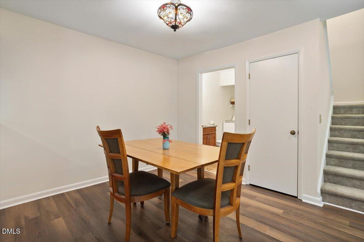 163 Springberry Lane Chapel Hill, NC 27517 - Photo 10 of 32 a view of a dining room with furniture and wooden floor