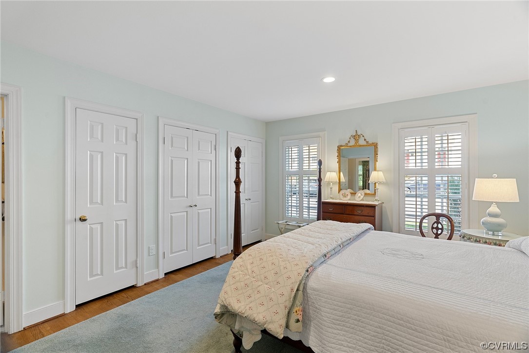 300 North Ridge Road, Unit 70 Henrico, VA 23229 - Photo 33 of 36 a bedroom with a large bed and wooden floor