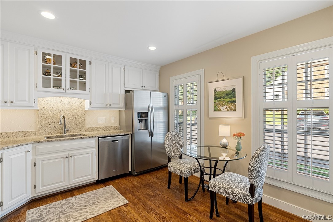 300 North Ridge Road, Unit 70 Henrico, VA 23229 - Photo 9 of 36 a kitchen with stainless steel appliances granite countertop a stove a sink dishwasher a refrigerator and white cabinets with wooden floor