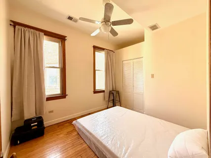 a bedroom with a bed dresser and a window