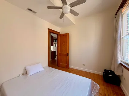 a bedroom with a bed and a dresser