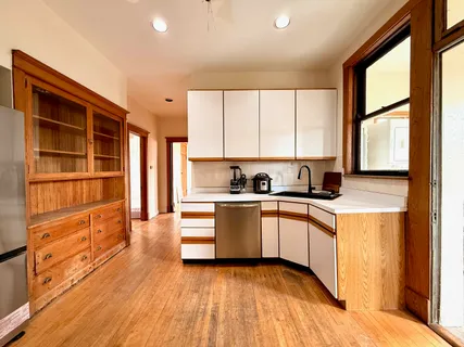 a kitchen with stainless steel appliances granite countertop a stove a sink and a refrigerator