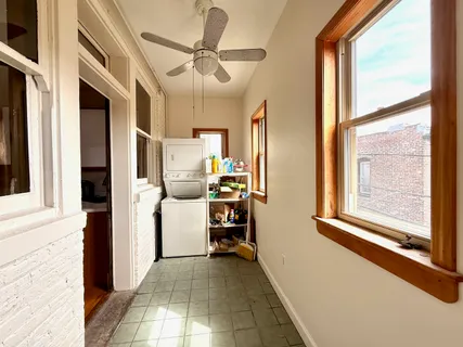 a view of a hallway with workspace and a window