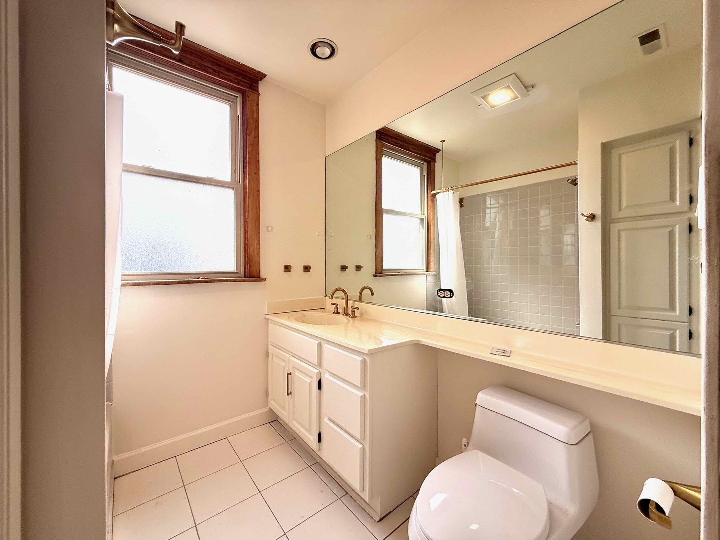 2414 North Spaulding Avenue, Unit 2F Chicago, IL 60647 - Photo 27 of 30 a bathroom with a sink a toilet and mirror