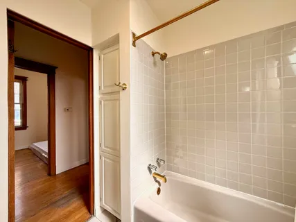 a bathroom with a bathtub and a shower