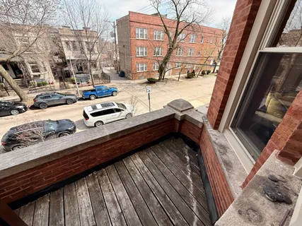 a view of balcony with two chairs and wooden floor