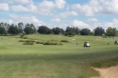 a bathroom with a double vanity sink a toilet a mirror and shower