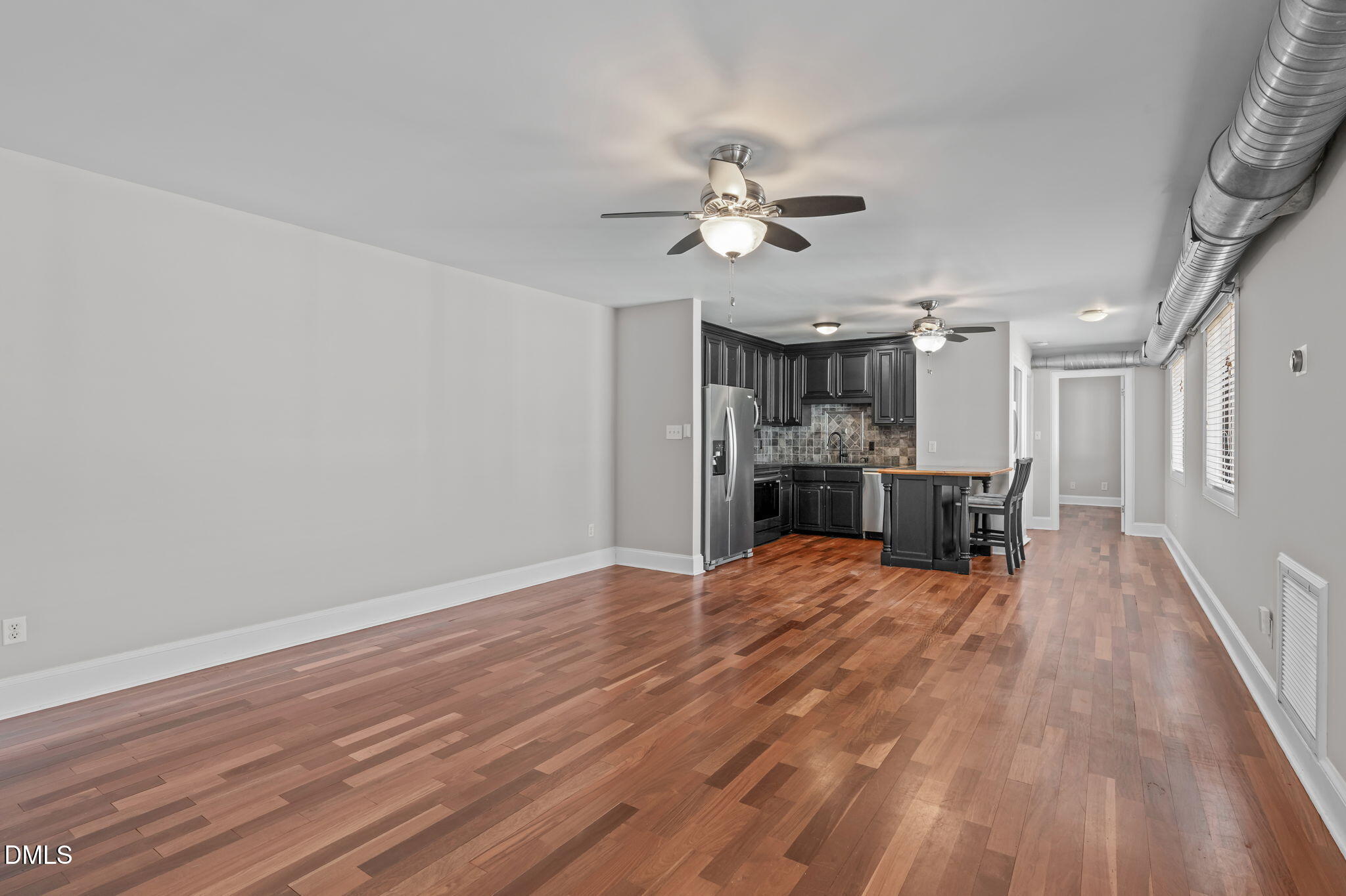 2208 Stafford Avenue Raleigh, NC 27607 - Photo 4 of 30 a view of a room with wooden floor and window