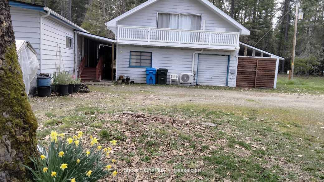 575 Kirkham Road Cave Junction, OR 97523 - Photo 36 of 45 a view of a house with a yard and sitting area