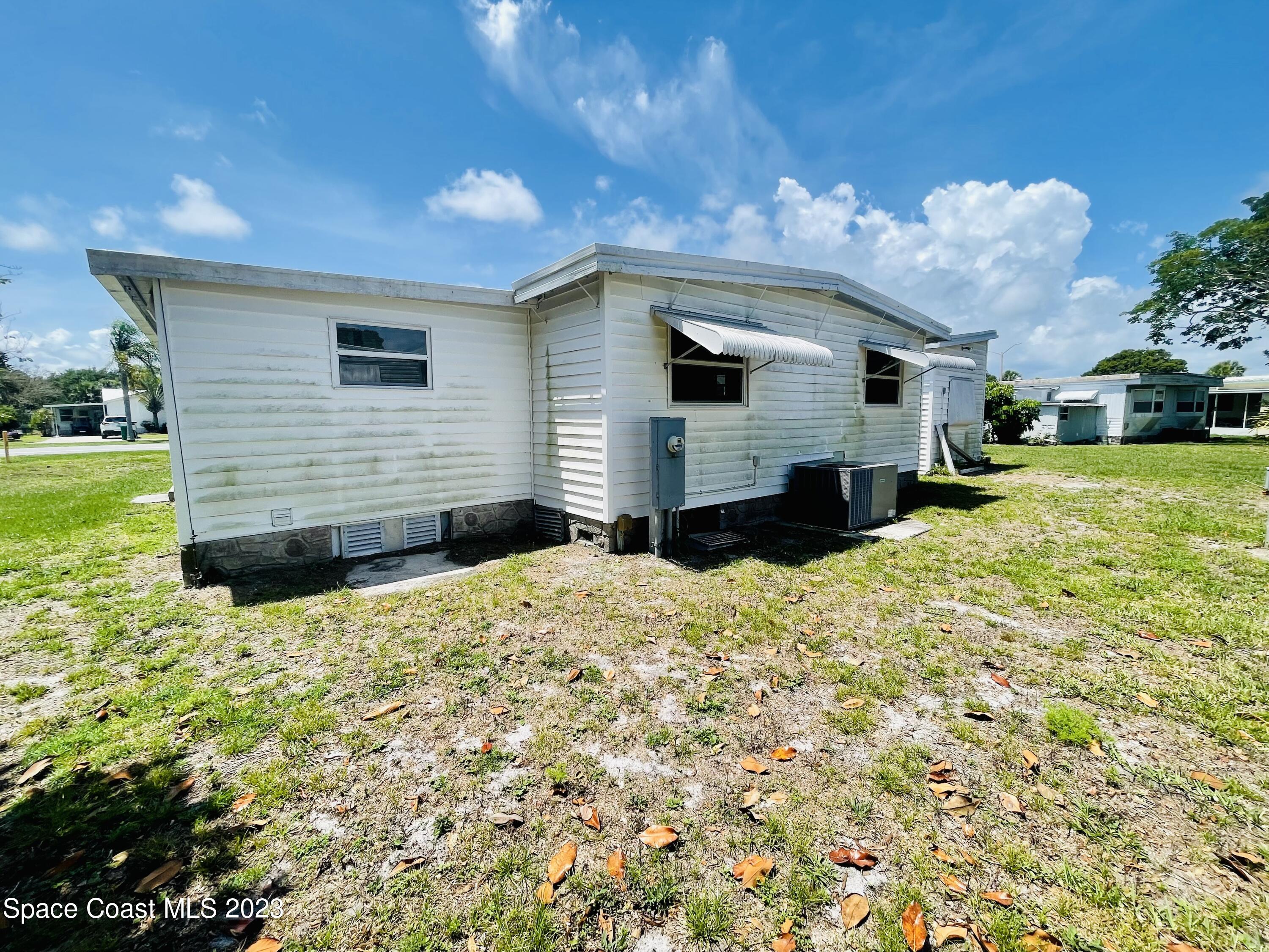 706 Barefoot Boulevard Barefoot Bay, FL 32976 - Photo 11 of 14 a front view of house with yard