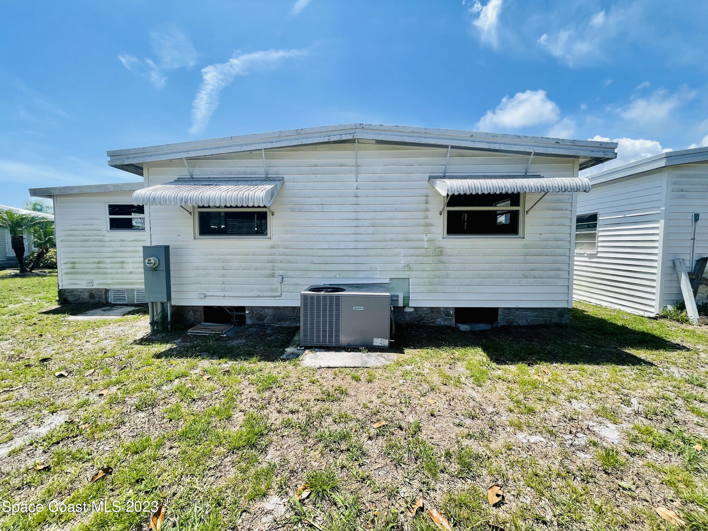 706 Barefoot Boulevard Barefoot Bay, FL 32976 - Photo 12 of 14 a front view of house with yard