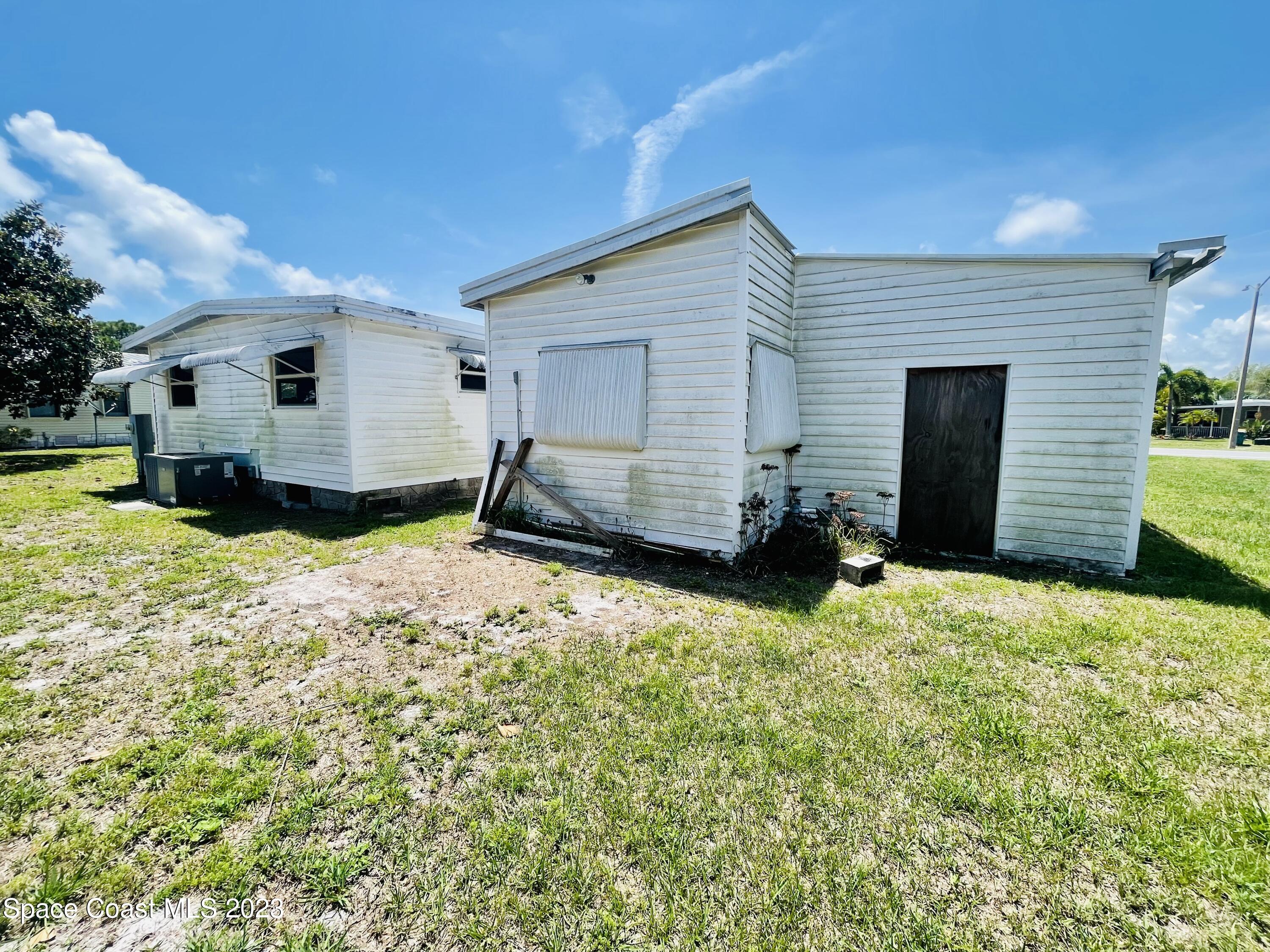 706 Barefoot Boulevard Barefoot Bay, FL 32976 - Photo 13 of 14 a view of a house with backyard
