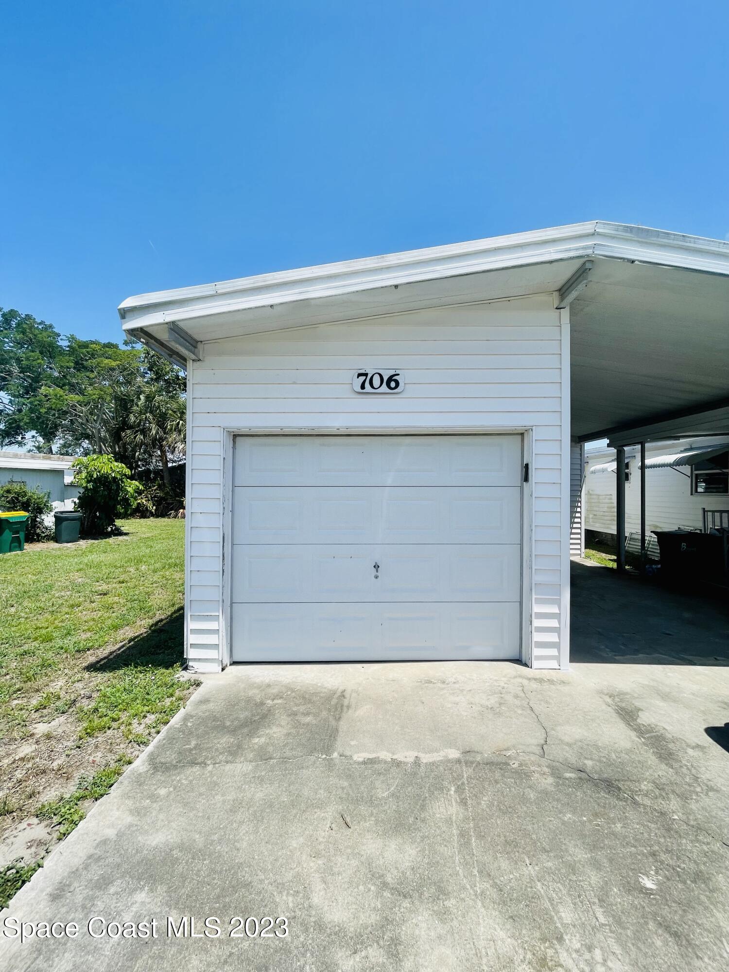 706 Barefoot Boulevard Barefoot Bay, FL 32976 - Photo 2 of 14 a front view of a house with a yard