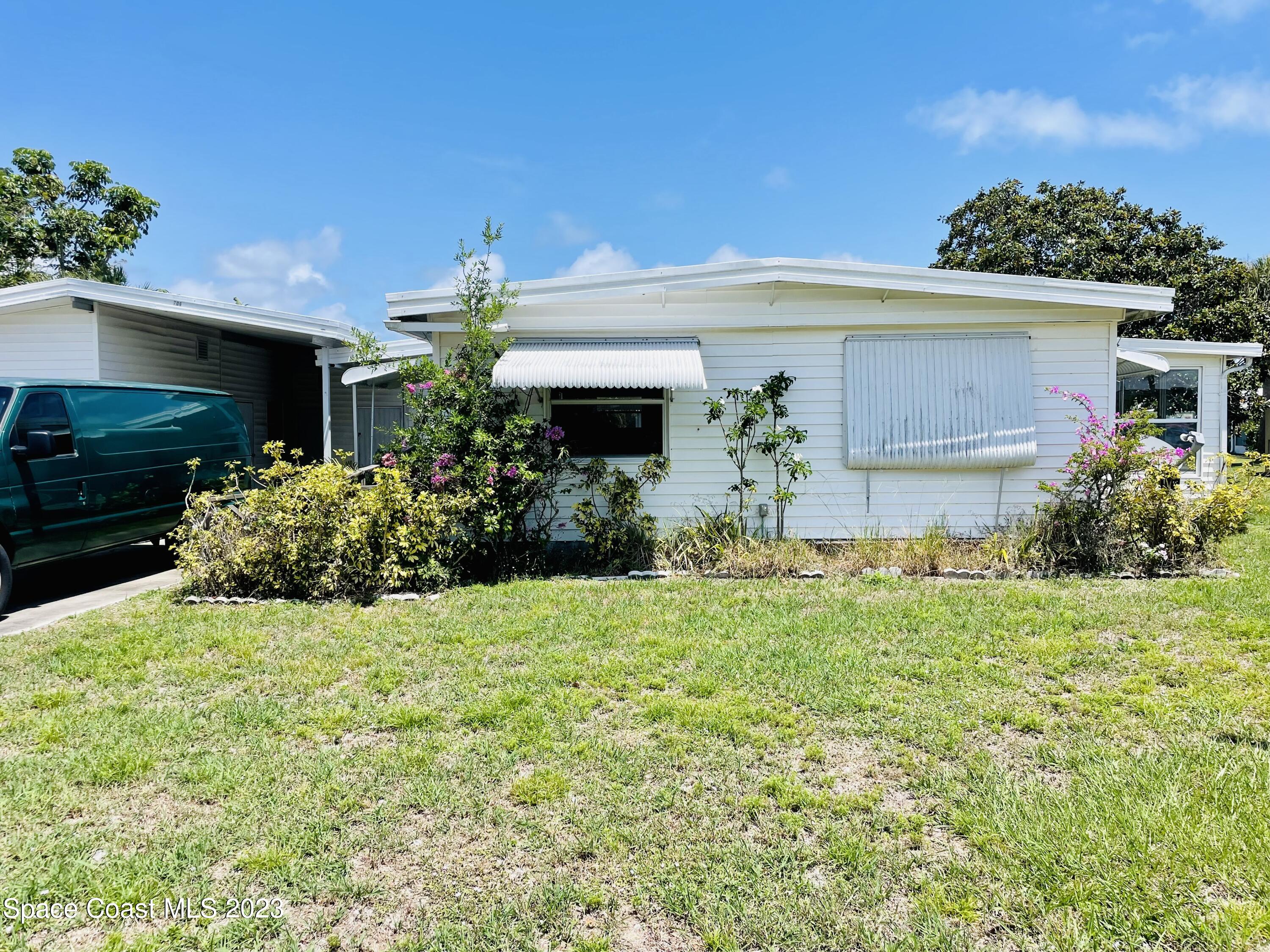 706 Barefoot Boulevard Barefoot Bay, FL 32976 - Photo 3 of 14 a front view of house with yard