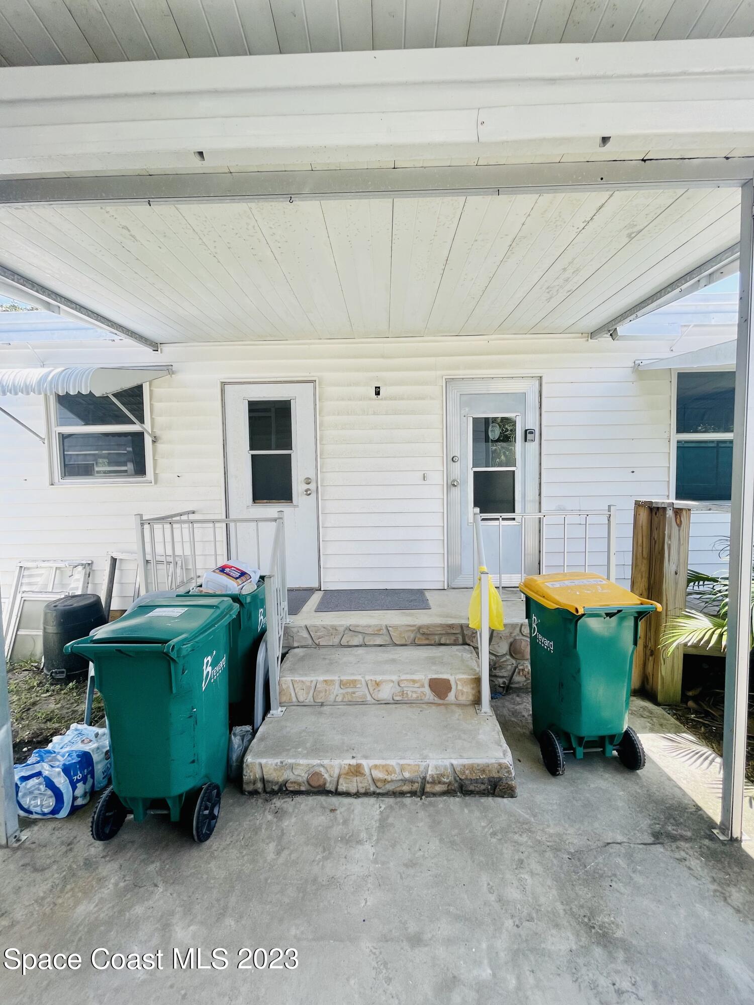 706 Barefoot Boulevard Barefoot Bay, FL 32976 - Photo 6 of 14 a living room with furniture and a window