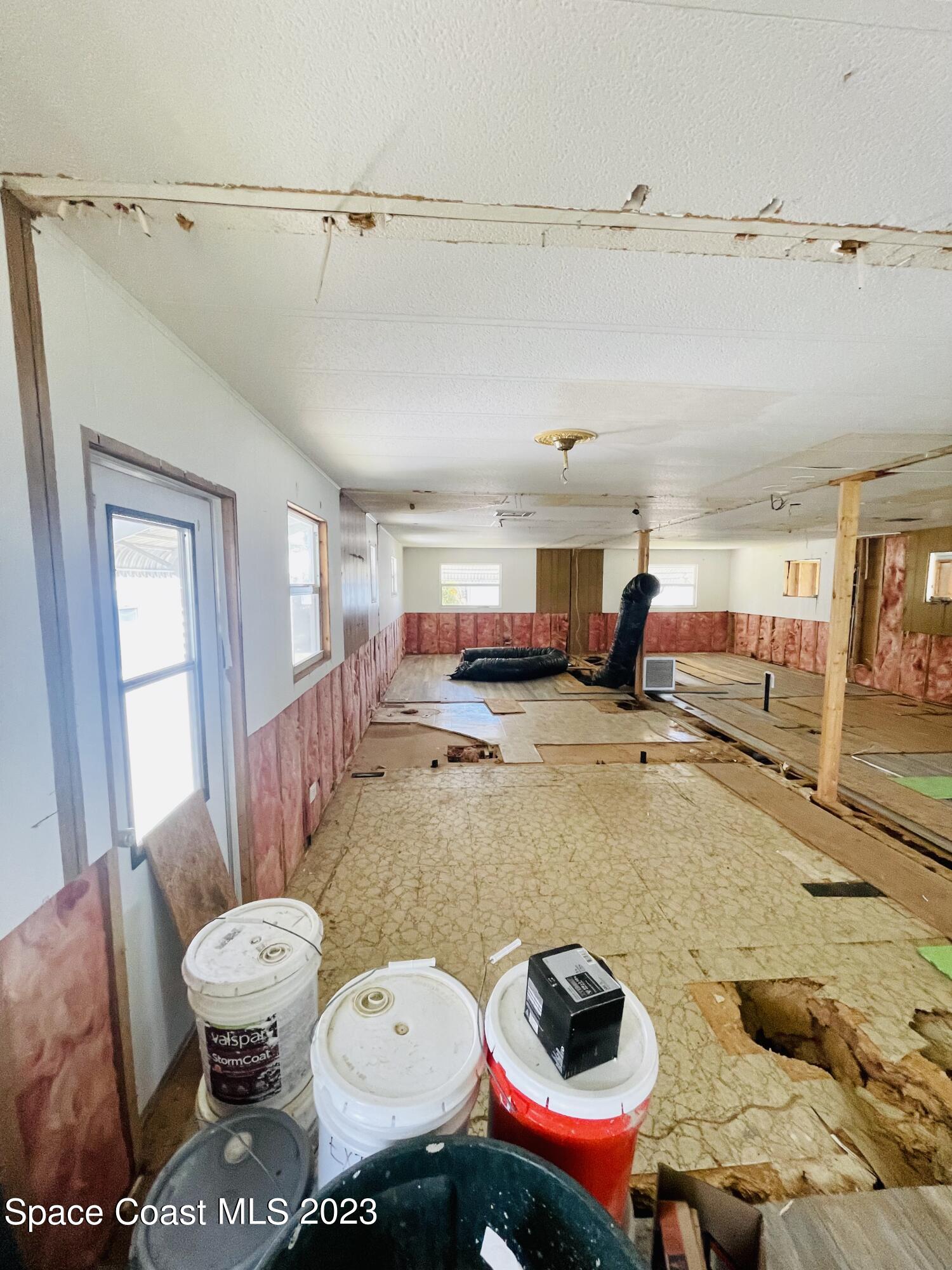 706 Barefoot Boulevard Barefoot Bay, FL 32976 - Photo 9 of 14 a living room with lots of furniture and a wooden floor