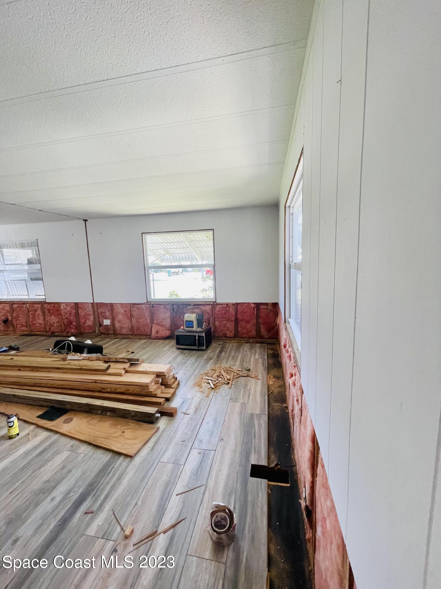 706 Barefoot Boulevard Barefoot Bay, FL 32976 - Photo 10 of 14 a view of a living room and bathroom