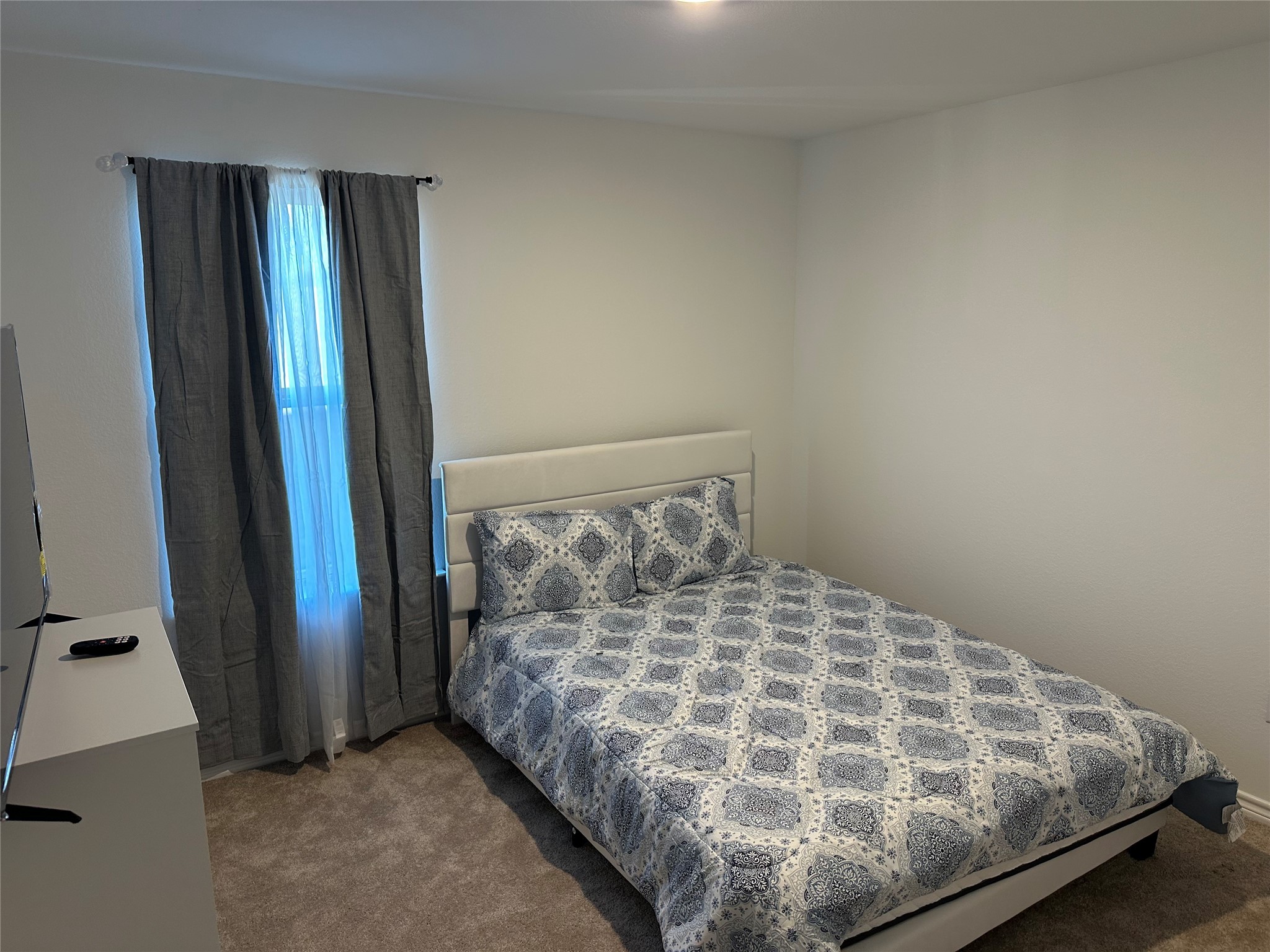 15214 Canyon Rapids Road Conroe, TX 77302 - Photo 11 of 22 a bed sitting in a bedroom next to a window